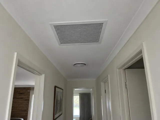 Ceiling return-air grille in a narrow hallway with white walls and doorways in Salisbury East